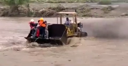 Rescue Of People From A Flooded Car On A Bulldozer