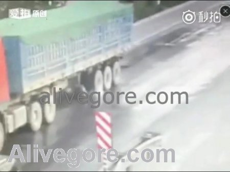 A cyclist drove under a truck