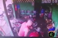 Man Being Executed In Motorcycle Shop