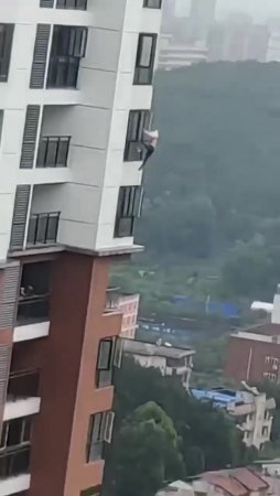 A Man Fell Off The Window Of A Multi-storey Building And Somersaults In Flight