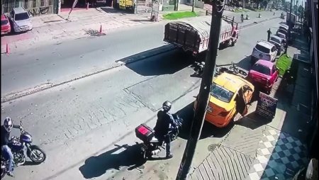 A Guy And A Girl On A Motorcycle Fell Under The Wheels Of A Truck