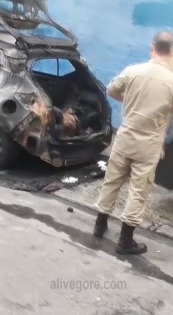 Cops Loading Coal From The Trunk Of A Burned-out Car