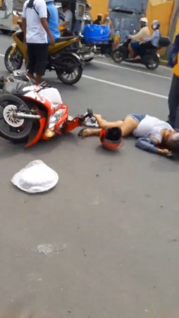 Woman On Motorcycle Falls Under Wheels Of Garbage Truck