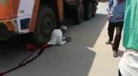 While A Man Is Still Alive Under The Wheels Of A Truck