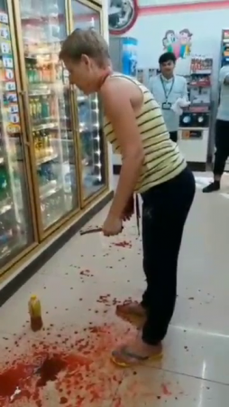 Crazy Woman Tries To Cut Her Own Throat In A Supermarket