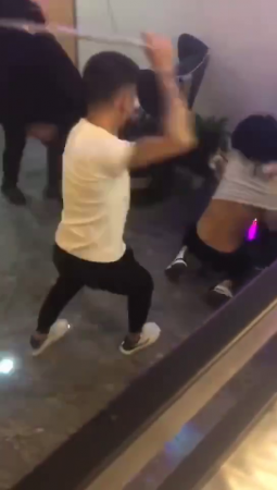 Several Young Men Are Beating And Kicking A Girl With Their Hands And Feet