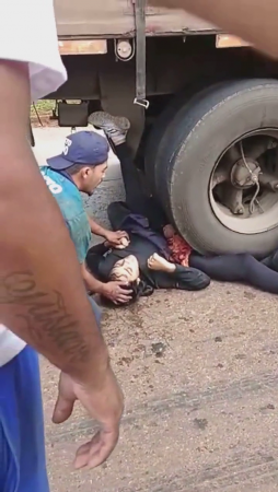Woman Motorcyclist Spread Her Legs Under The Wheels Of A Truck