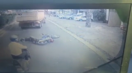The Car Pushed The Motorcyclist Under The Wheels Of The Truck