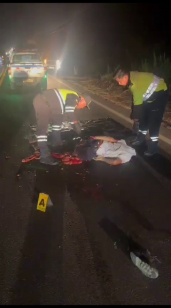 The Shapeless Body Of A Man Hit By A Car Is Removed From The Road