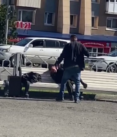 Bastard Beating A Homeless Man On A Bench. Kamchatka, Russia