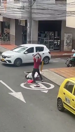 An Aggressive Idiot Attacked A Man With A Stick Who Was Tearing Down Advertisements