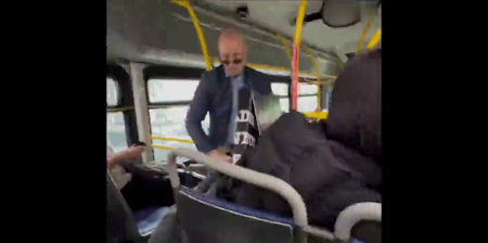 Blue Hair Person And Man With A Sign Have A Disagreement On A Bus. Canada