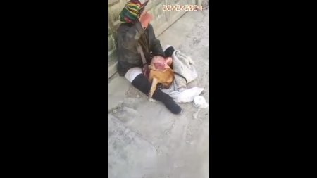Woman Sitting On The Street Skins A Dead Dog