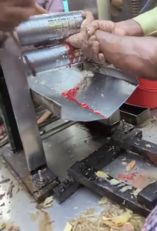 The Worker's Hand Is Crushed By A Dough-Spreading Machine