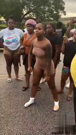 Fight Between Two Women On The Street. One Athlete Half Naked