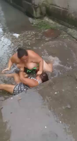 A Huge Woman Tried To Drown Her Rival In A Puddle