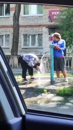 Hygiene First Of All! A Woman Washes Her Ass In A Faucet Outside. Ukraine