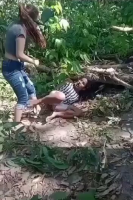 Woman Beating A Tied Up Woman In The Forest