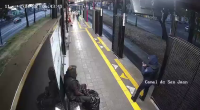 At A Metrobus Station, A Homeless Man Pushed A Policewoman Off The Platform In Front Of An Approaching Bus