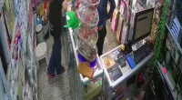 The Wife Was Distracting The Store Clerk While Her Husband Stole A Mobile Phone From Behind The Counter