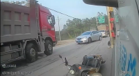 A Female Passenger On A Scooter Dive Under A Truck