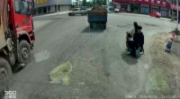 A Dump Truck Drove Over The Heads Of Two People Who Fell From A Motorcycle